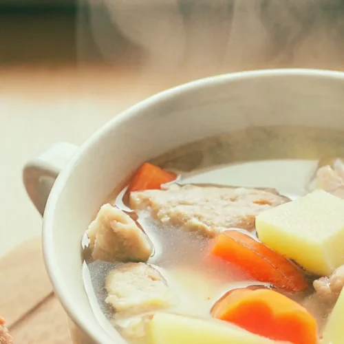 Grandma's chicken soup with herbs, carrots, and noodles